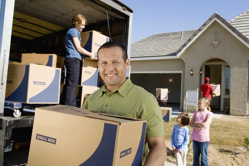 Compact moving team managing boxes during a Camden small removal